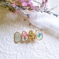 Detail view of handmade gold floral hair clip with dried flowers and resin petals - White