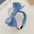 Blue fabric headband with a double-layered oversized bow design and knotted center finish - Light Blue Denim