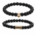 Men's beaded bracelets with gold skull and rhinestone cylinder charms on white background - Polished Stone Gold Skull Set