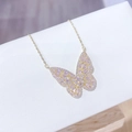 Elegant gold butterfly pendant necklace with pink zircon stones on a white jewelry box - Gold Pink