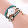 Detail of green snake pattern wrap strap watch with gold case and pendant on wrist - Lake Blue (Green Snake Pattern)