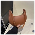 Close-up of brown crescent underarm bag showing smooth texture and golden metal buckle - Dark Brown