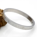 Close-up of silver metal bracelet featuring engraved Roman numerals and sleek buckle - 8MM Roman Numerals Bangle Silver