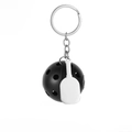 Detailed view of metal pickleball keychain featuring black ball and white paddle charms - Black Pickleball Paddle