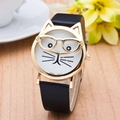 Close-up of cat-shaped gold watch with whiskers dial and black leather strap on desk - Black