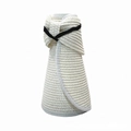 Detail of white straw sun hat featuring a black elastic band and foldable roll-up design - White