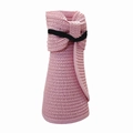 Detail of pink straw sun visor featuring woven texture and black ribbon bow detail - Pink
