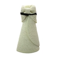 Foldable detail of a beige straw sun visor hat with a black bow and woven texture - Milky White