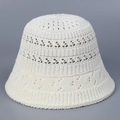 Detailed close-up of breathable hollow-out crochet texture on a beige knit bucket hat - M (56-58cm) / White