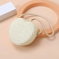 Macro shot of heart-shaped woven straw bag texture with zipper and rope strap details - White
