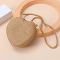 Close-up of heart-shaped woven straw shoulder bag with detailed natural texture - Brown