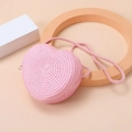 Detailed view of pink heart-shaped straw bag with intricate woven texture on warm background - Water Pink