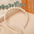 Detailed view of layered faux pearls on an elegant headband with a soft silk background - Pearl Array