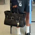 Minimalist black oversized leather tote bag with belt buckle details and charm - Black