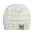 Detail of soft white cable knit texture and MOK leather tag on baby winter beanie - White