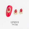 Detailed macro view of 7x11mm ruby red teardrop nail crystal with gold base and rhinestones - Gold Frame Deep Red Water Drop Style (5213)