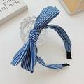 Blue and white striped fabric headband with a large bow on a minimalist desk - Dark Stripes