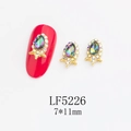 Close-up of 7x11mm AB crystal teardrop nail art charms with gold alloy base and small rhinestones - Gold Frame Aurora AB Water Drop Style (5226)