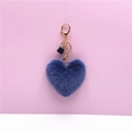 Detailed view of dusty blue plush heart keychain with gold hardware and black silk tassel - Blue
