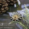 Detailed view of daisy and bee brooch with blue enamel petals and golden metal finish - Daisy Bee Blue Gold Style