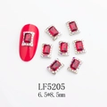 Detail view of 6.5x8.5mm red rectangle K9 glass nail art gems with silver metal frame - Silver Frame Step Cut Red Rectangle Style (5205)