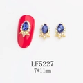 Detailed view of 7x11mm blue teardrop nail art gem with iridescent stones on gold base - Gold Frame Blue with AB Edge Water Drop Style (5227)