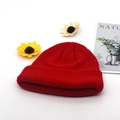 Vibrant red knit beanie hat in solid color shown with sunflower and art card - Adjustable / Red