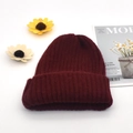 Detailed close-up of dark red ribbed knit beanie with warm fold-over cuff design - Burgundy