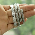 Detailed close-up of a three-piece silver men's bracelet set with Roman numerals and braid - Round End Silver Set
