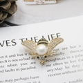 Elegant bee brooch with diamond-set wings and a large pearl on a gold-tone base - Large Pearl Gold Base Bee Style