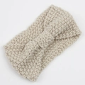 Detailed close-up of beige chunky knit headband with bow design on white background - Beige