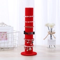Red velvet vertical jewelry stand displaying assorted bracelets and watches - Red Velvet