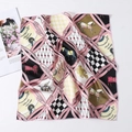 Detailed view of silk square scarf featuring equestrian chain horse motifs in pink and gold - 50cm x 50cm / Pink Black Horse Chain
