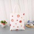 Minimalist cream canvas tote bag with red strawberry print and sturdy shoulder handles - Strawberry