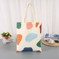 Canvas tote bag with colorful abstract patches and beige handles for daily shopping - Multicolor