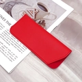 Chic red faux leather glasses pouch with top flap closure in a lifestyle setting - Red Plain