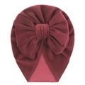 Detail view of burgundy velvet baby turban hat with a large decorative soft bow - Burgundy