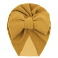Detail of ginger yellow baby turban hat with oversized knit bow on a white background - Turmeric