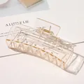 Macro shot of large matte champagne gold hair claw clip with golden metal spring detail - 10.5cm Rectangular - Glossy Champagne