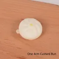 Realistic 4cm custard bun squishy toy with yellow top dot and keyring attachment - 4cm Custard Bun Squishy