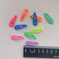 Detail view of colorful 3cm metal snap hair clips with smooth glossy finish - Waterdrop Style