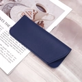 Dark blue litchi pattern PU leather sunglass case with fine stitching in lifestyle setting - Dark Blue Flat Grain