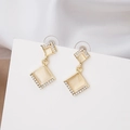 Detail view of double-layered square earrings with white zircons and opal stones - Gold Square Stacked Cat Eye