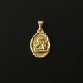Macro shot of 18K gold-plated oval pendant featuring an embossed vintage cherub angel design - M09 Pensive Angel
