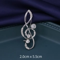 Silver treble clef music note brooch with sparkling crystals on dark silk background - G-Clef Silver (XD9114)