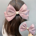 Pink satin double layer bow hair clip with pearls and rhinestones shown on hair - Spring Clips / Lotus Pink
