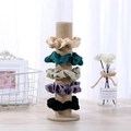 Cylindrical linen display stand for scrunchies and bracelets in a lifestyle setting - Linen