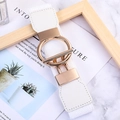 Minimalist white elastic waist belt with gold geometric buckle on a marble surface - White