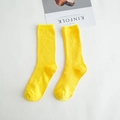 Vertical ribbed yellow cotton crew socks for women displayed on a clean white surface - Yellow