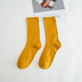Vibrant yellow mid-calf cotton socks in knitted texture with ribbed cuffs for women - Turmeric